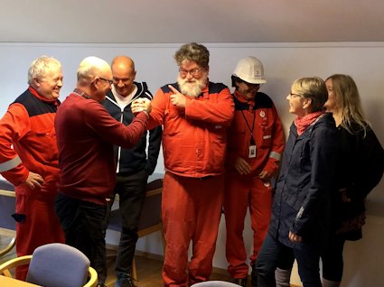 a group of people in red jumpsuits