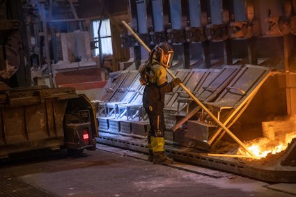 a firefighter standing next to a fire truck